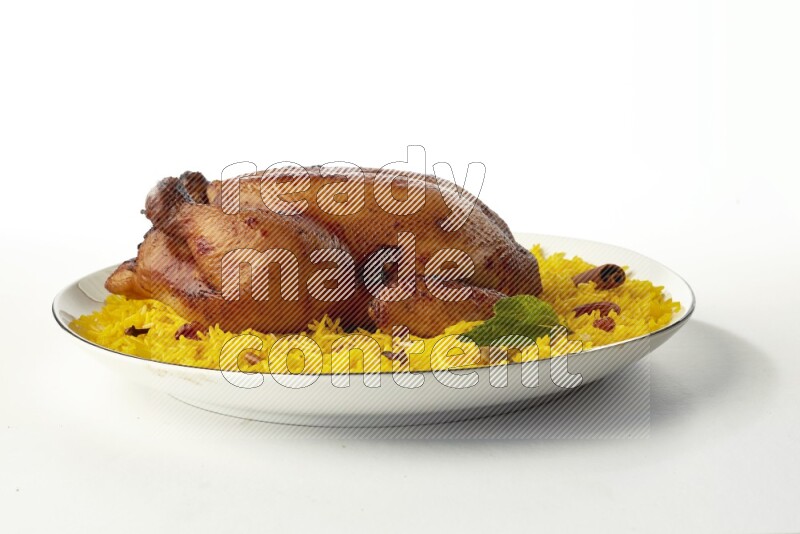 yellow  basmati Rice with kabsa chicken pieces on a white plate with a silver rim direct on white background