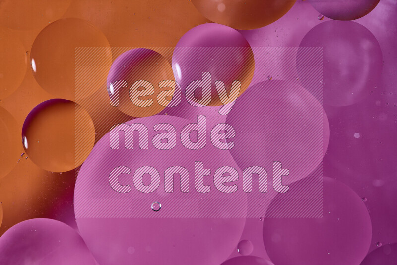 Close-ups of abstract oil bubbles on water surface in shades of orange and pink