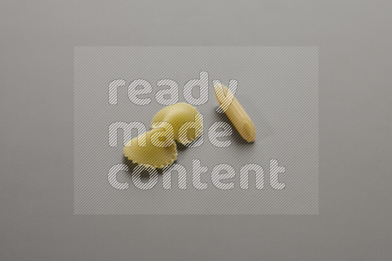 Fiocchi pasta with other types of pasta on grey background