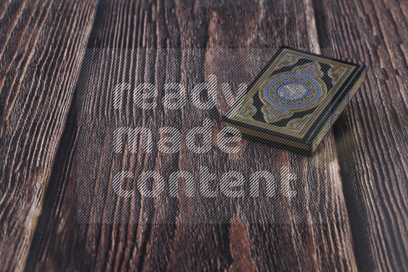 Quran with a prayer beads on wooden background