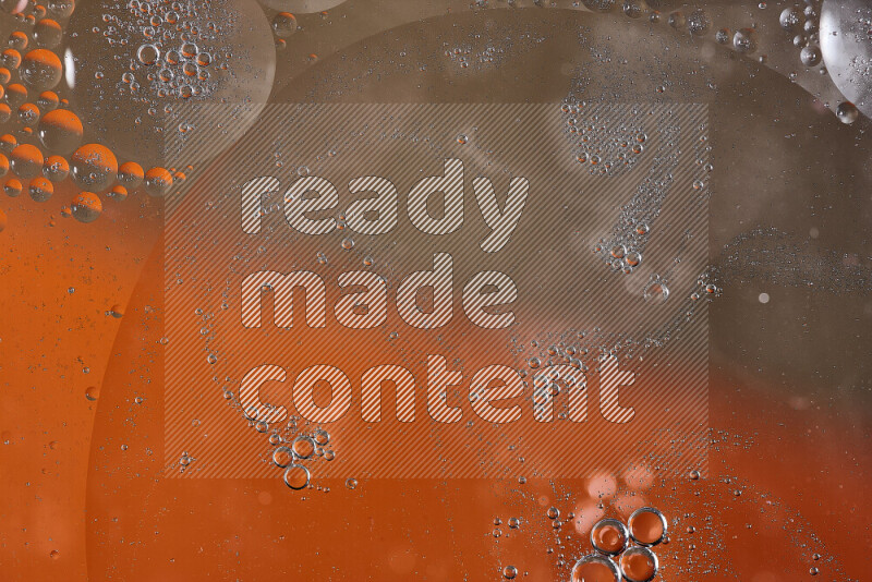Close-ups of abstract oil bubbles on water surface in shades of orange and brown