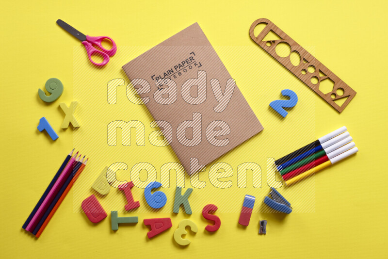 Different school supplies on yellow background