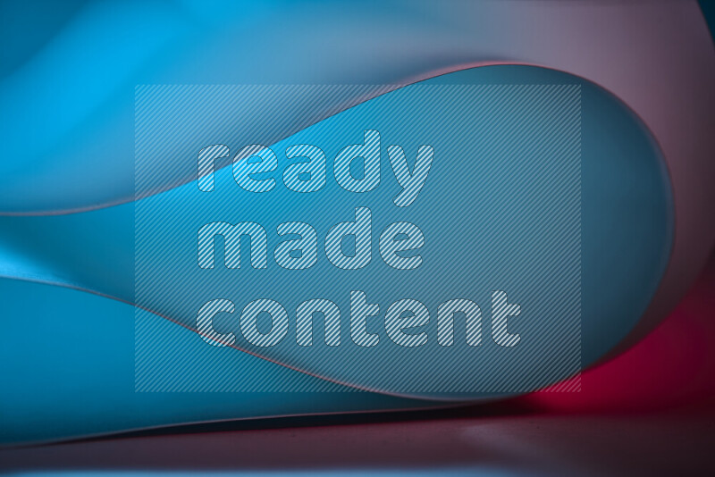 An abstract art piece displaying smooth curves in blue and red gradients created by colored light