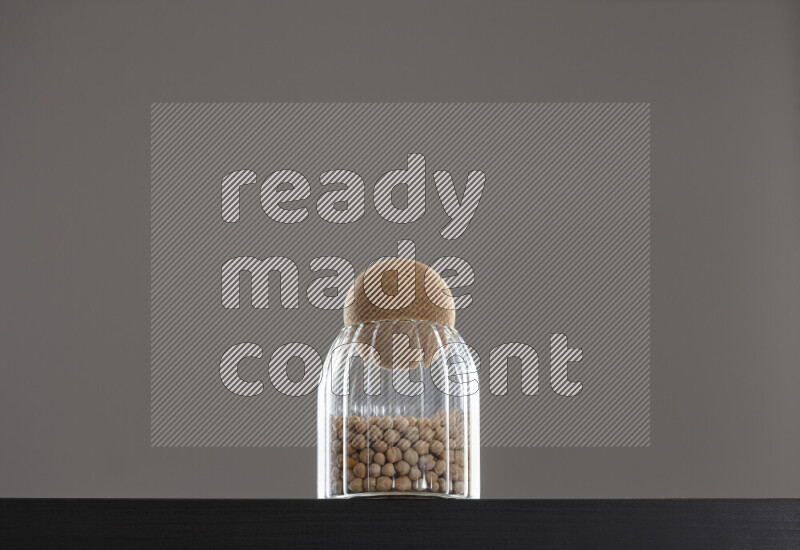 Chickpeas in a glass jar on black background