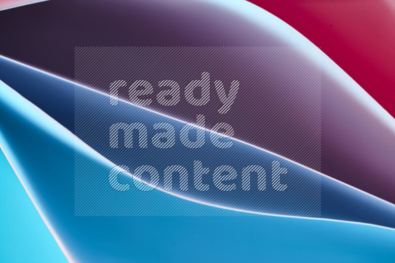 This image showcases an abstract paper art composition with paper curves in blue and red gradients created by colored light