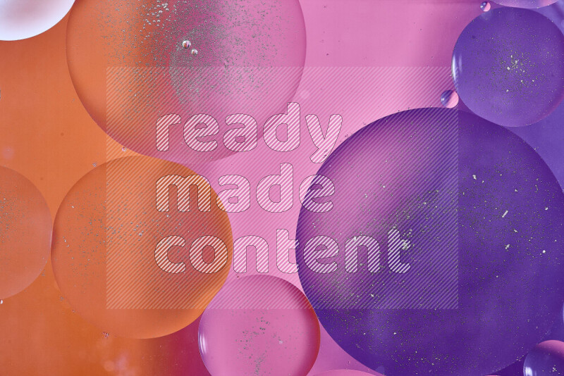Close-ups of abstract oil bubbles on water surface in shades of purple, orange and pink