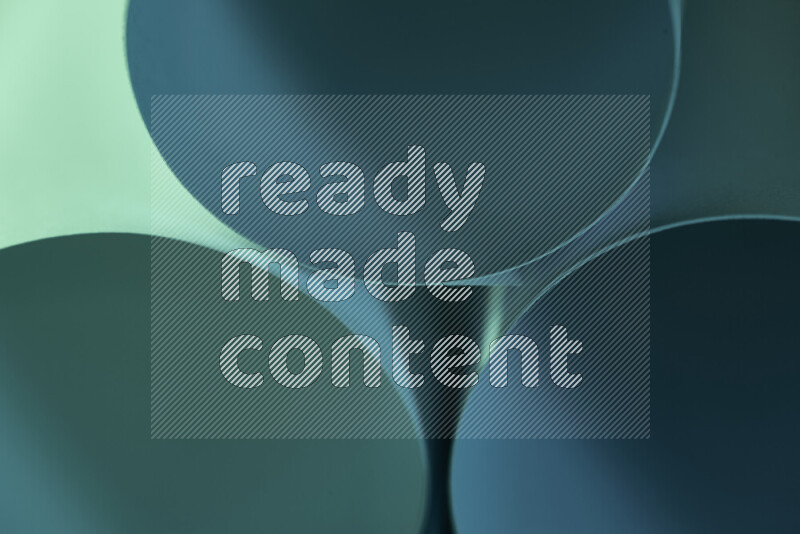 الصورة تعرض فن ورقي تجريدي بأشكال دائرية بدرجات متنوعة من اللون الأخضر والأزرق