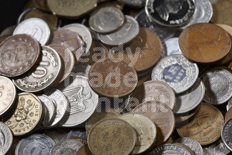 A close-ups of random old coins on black background