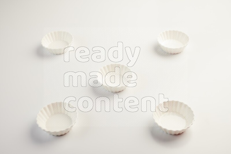 white ceramic round sauce dish on white countertop