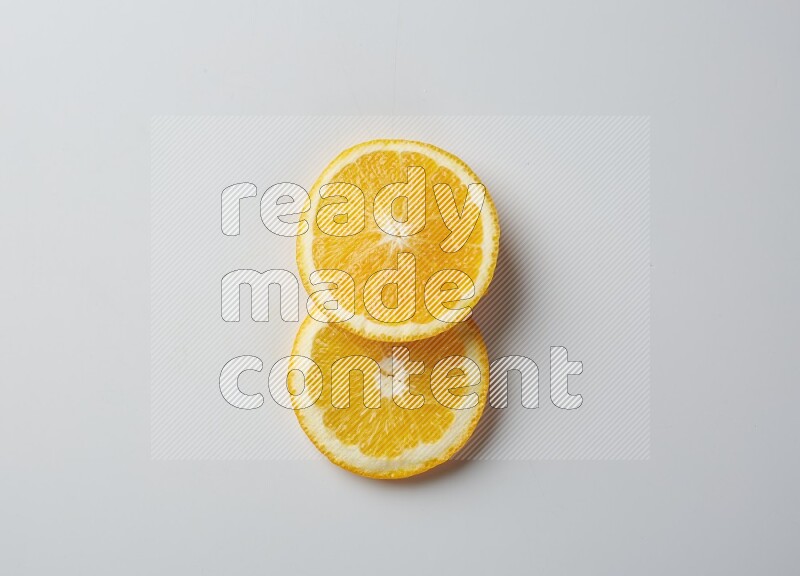 Two orange slices on white background