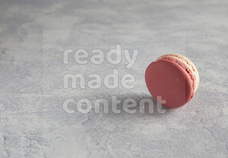 45º Shot of Pink Litchi Raspberry macaron on white  marble background