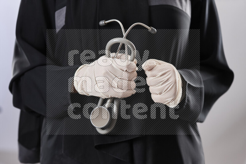 Female doctor wearing an abaya and medical attire in different positions