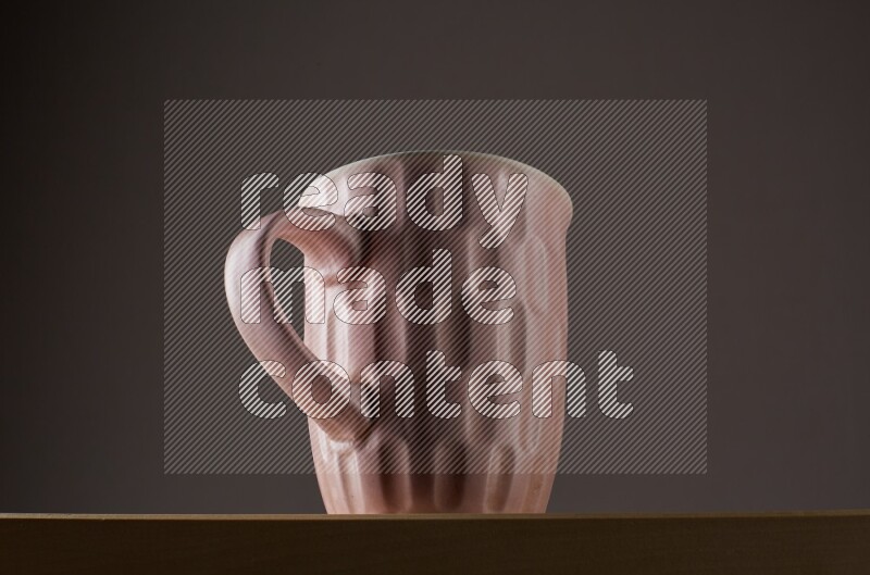 Low angle shot of a pink cup on grey background