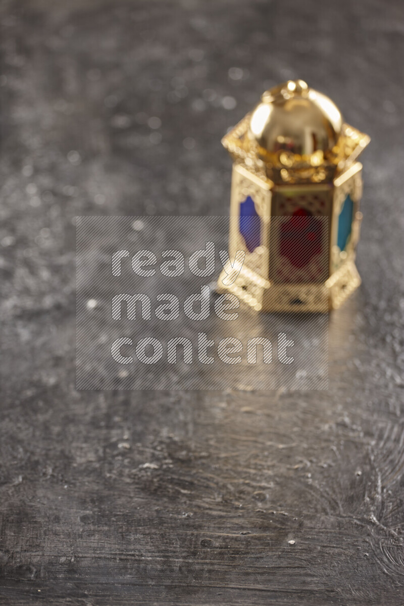 A lantern placed on a textured black background