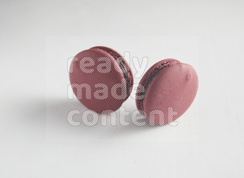 45º Shot of two Red Cherry macarons on white background