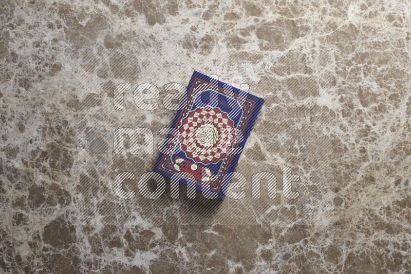 The holy Quran on beige marble background