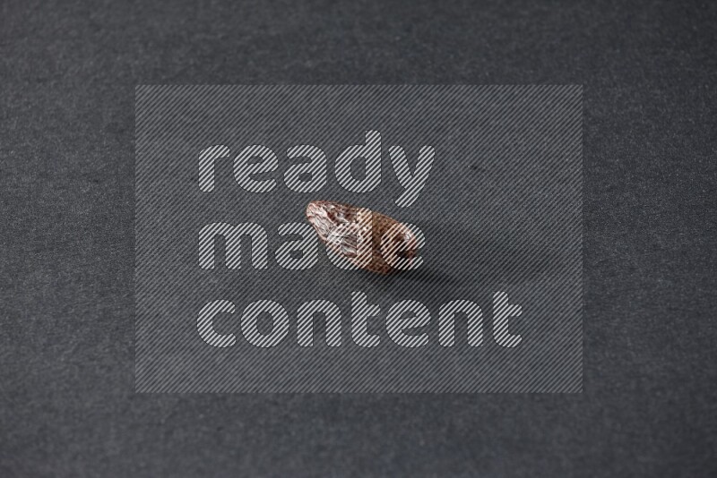 Dried dates on a black background in different angles