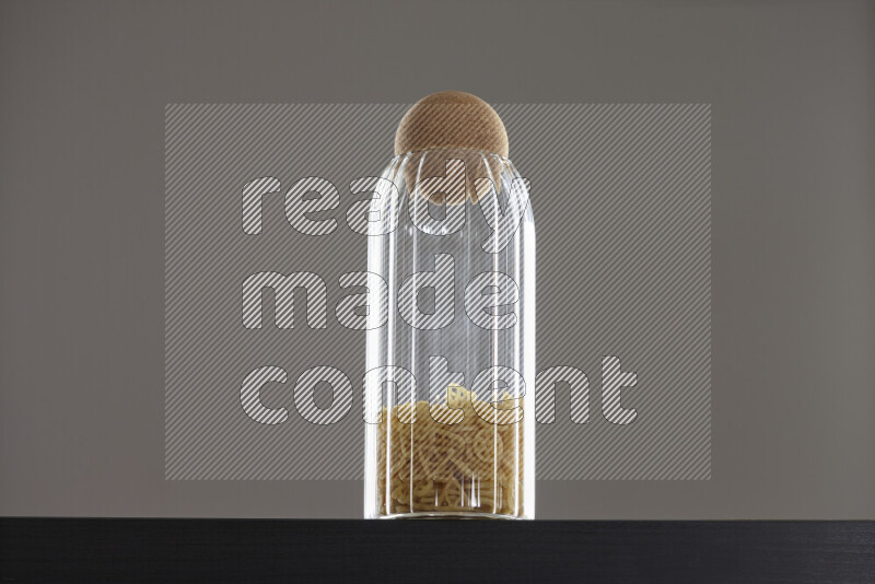 Snacks in a glass jar on black background