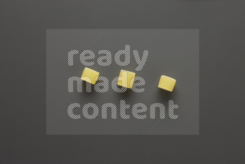 Big rings pasta on grey background