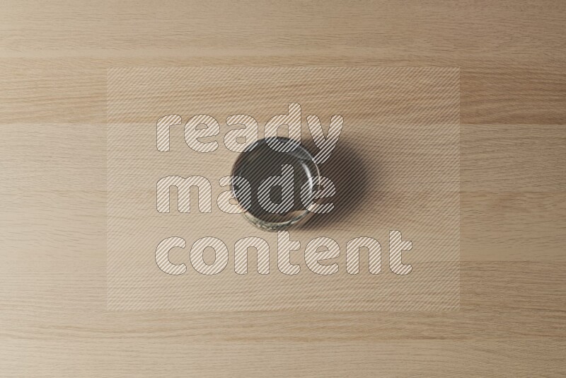 A multicolored pottery bowl on light wooden background