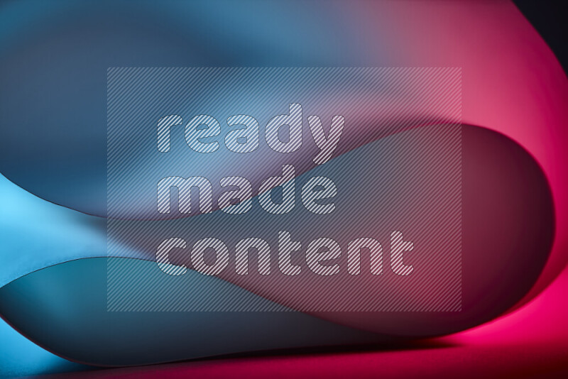 An abstract art piece displaying smooth curves in blue and red gradients created by colored light