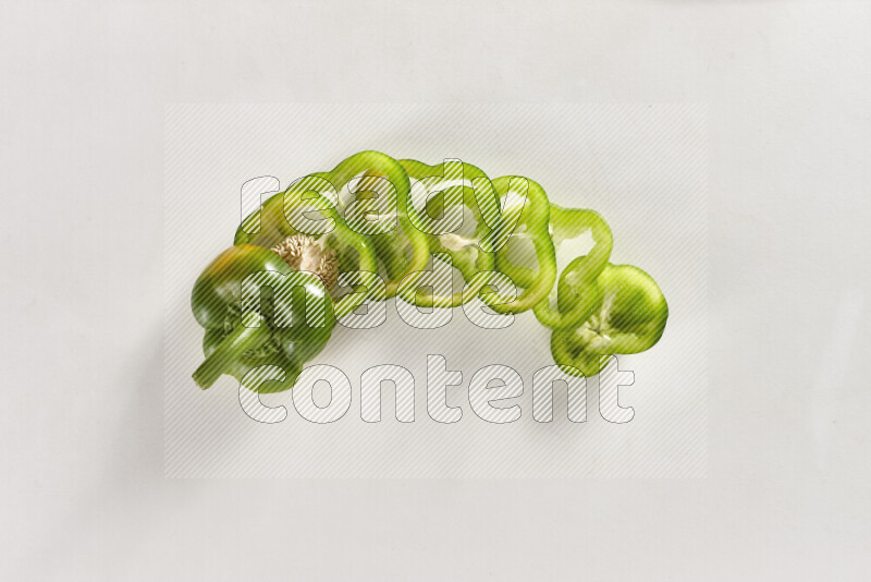 Green bell pepper slices on white background
