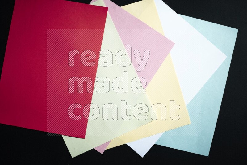 Multicolored paper sheet on black background