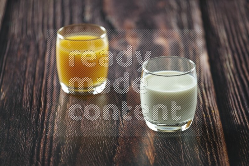 Cold drinks in a glass cup such as water, tamarind, qamar eldin, sobia, milk and hibiscus on wooden background