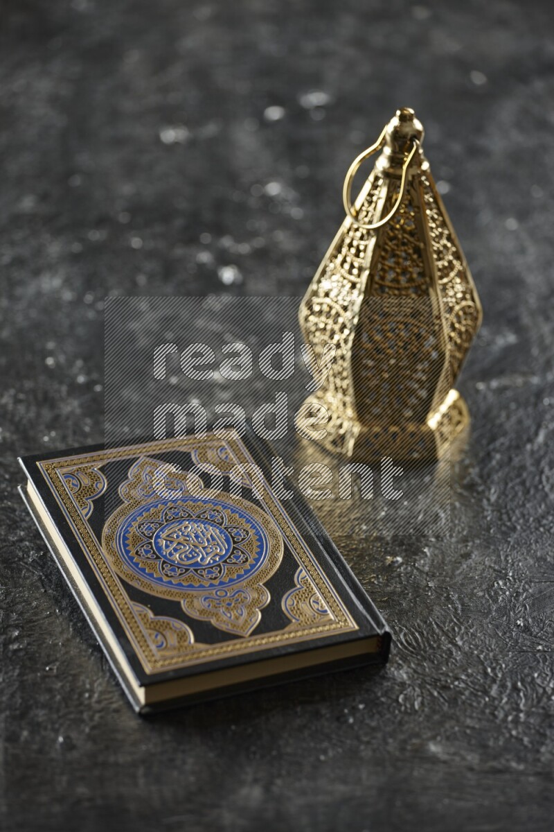 A golden lantern with different drinks, dates, nuts, prayer beads and quran on textured black background