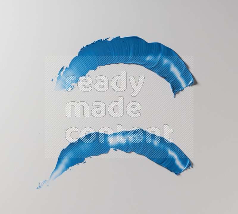 Blue curved painting knife strokes on white background