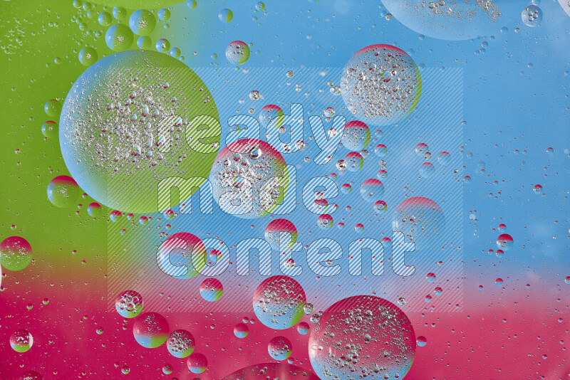Close-ups of abstract oil bubbles on water surface in shades of pink, green and blue