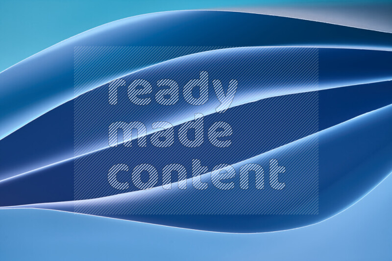 This image showcases an abstract paper art composition with paper curves in blue gradients created by colored light