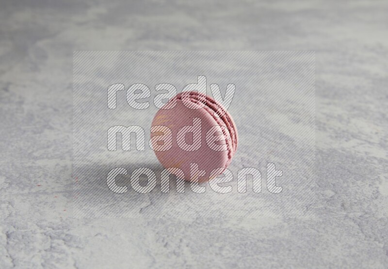 45º Shot of Purple Strawberry macaron on white  marble background
