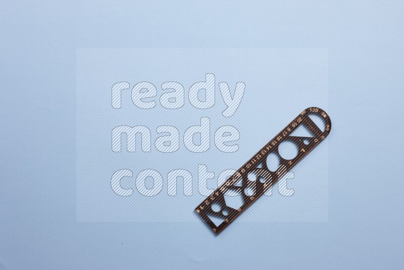 A wooden ruler on blue background