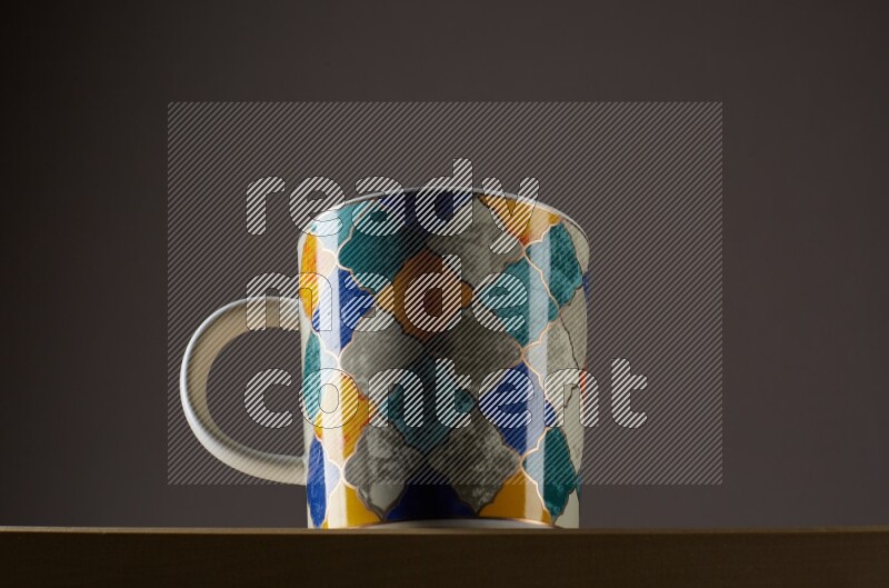 Low angle shot of a decorated cup on grey background