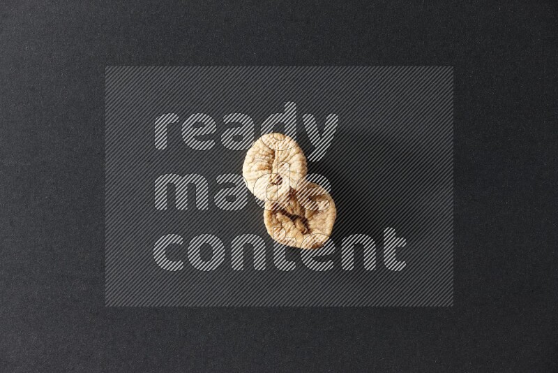 Two dried figs on a black background in different angles