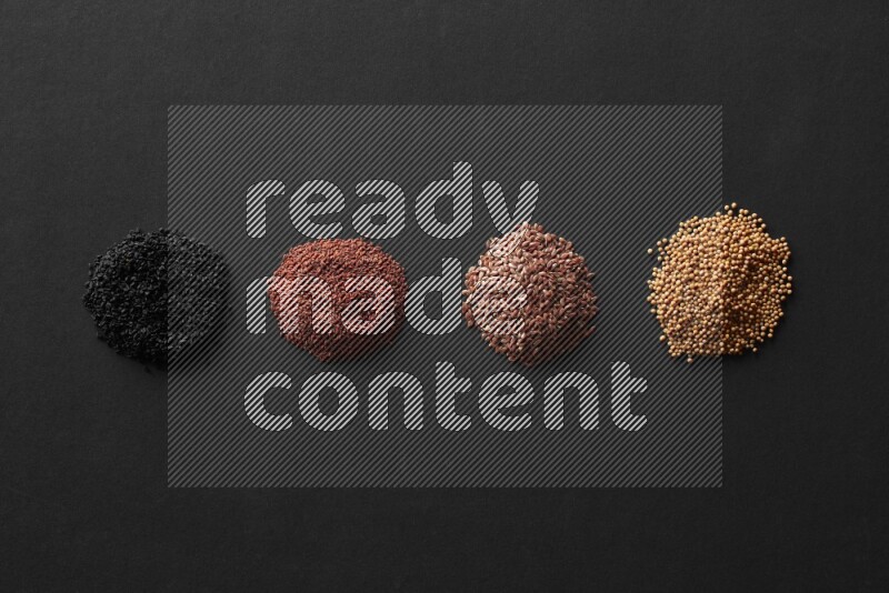 Black seeds, mustard seeds, garden cress and flax on a Black background