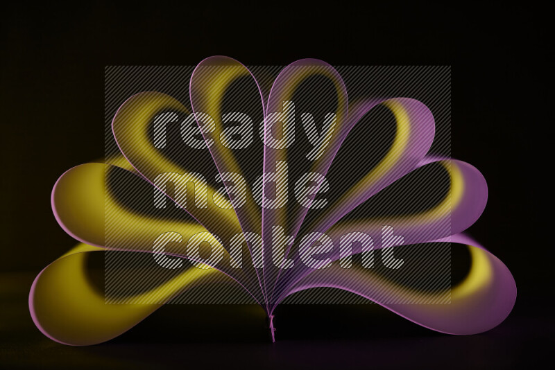 An abstract art piece displaying smooth curves in yellow and pink gradients created by colored light