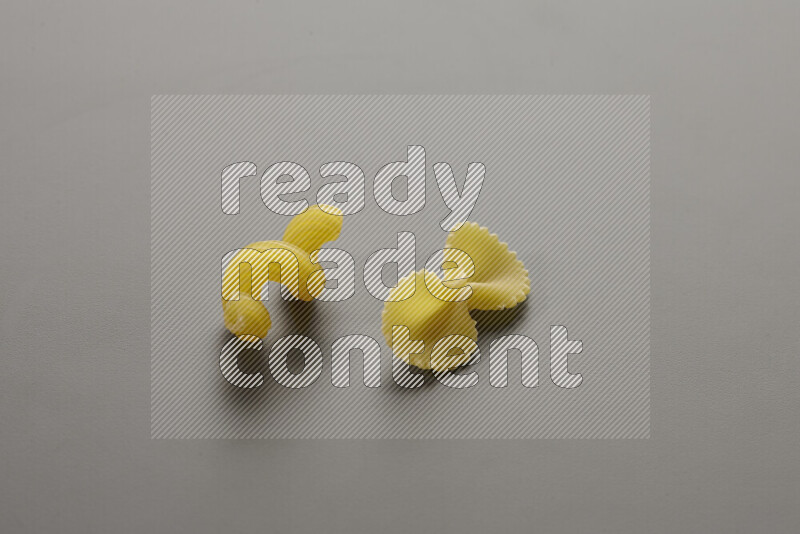 Twist pasta with other types of pasta on grey background