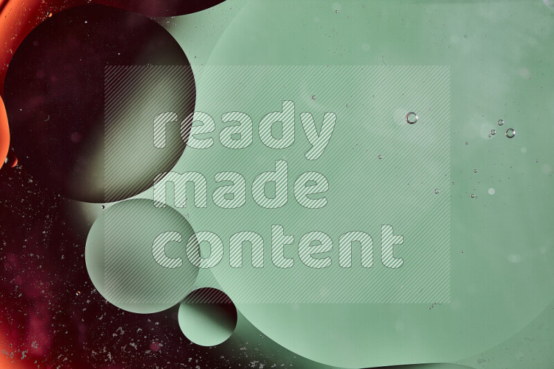 Close-ups of abstract oil bubbles on water surface in shades of green and orange