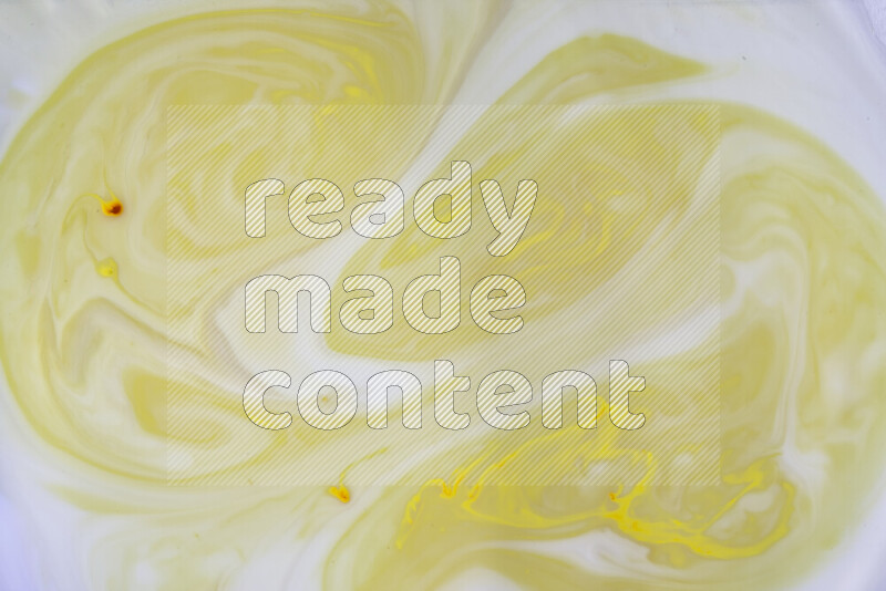 A close-up of abstract swirling patterns in yellow and white