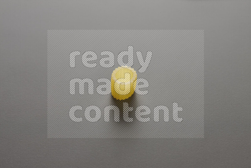 Big rings pasta on grey background