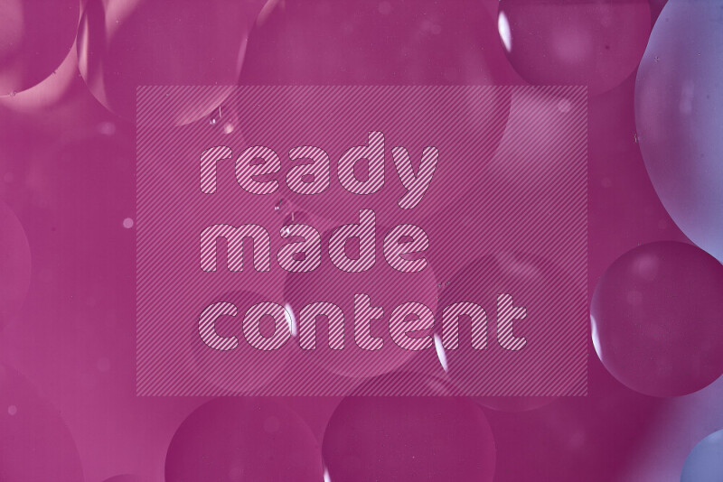 Close-ups of abstract oil bubbles on water surface in shades of white and pink