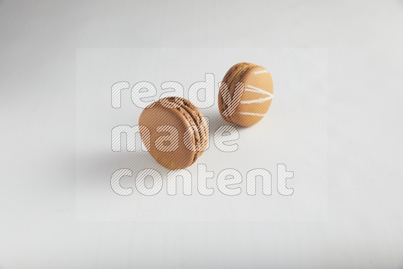 45º Shot of of two assorted Brown Irish Cream, and Brown Coffee macarons  on white background