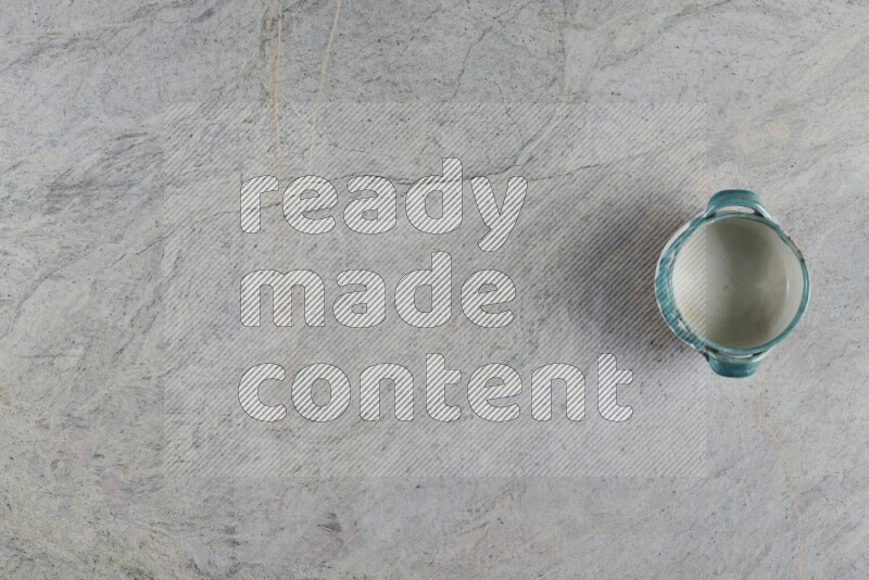 A multicolored pottery Bowl on grey marble background