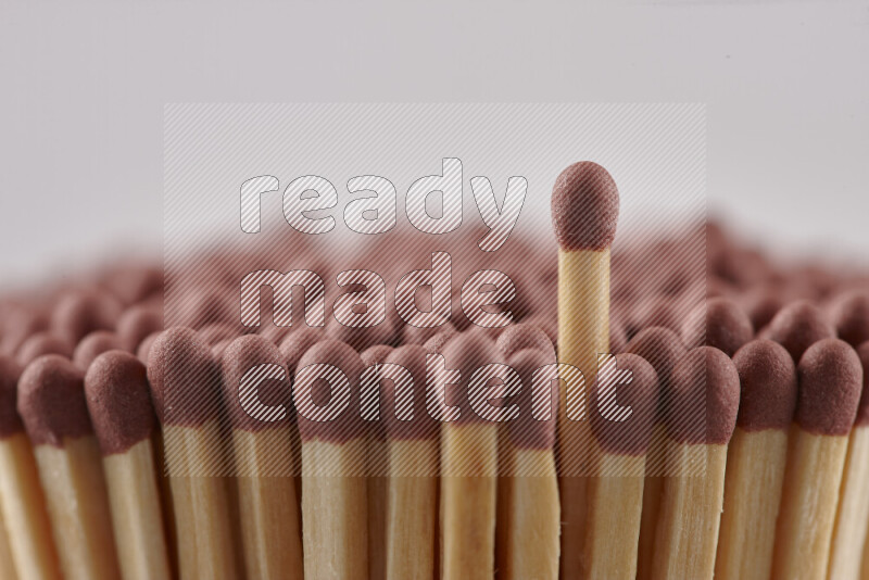 A close-up of a bundle of matches on grey background