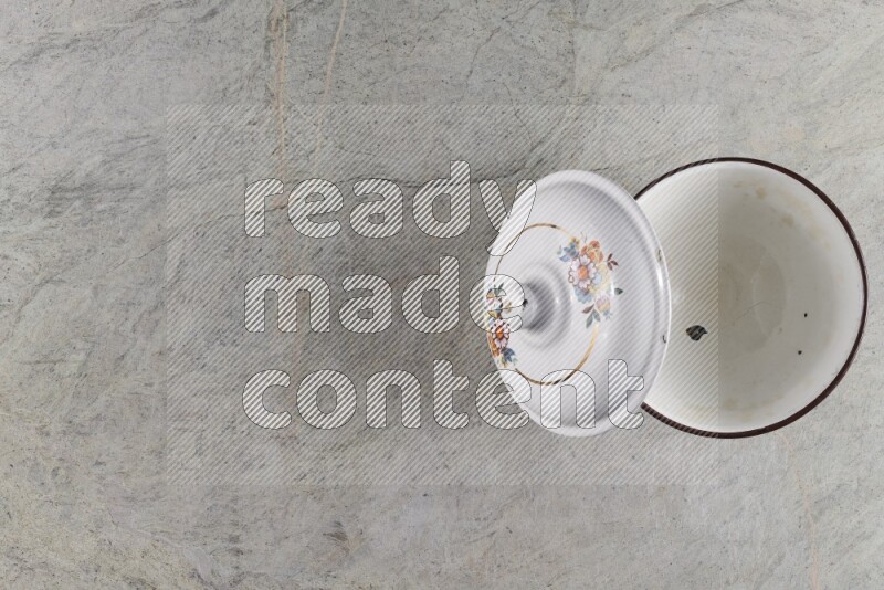 A vintage metal pot on grey marble background