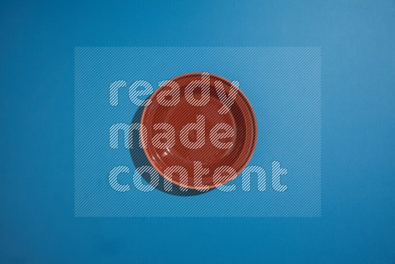 brown bowl on blue background