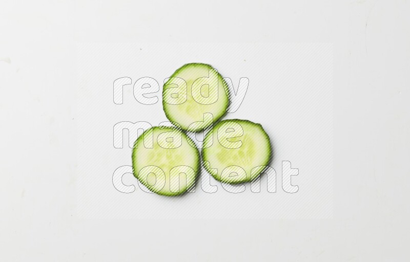 three cucumber slices on white background