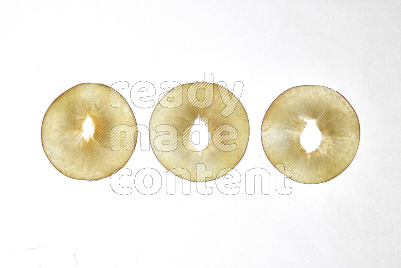 Peach slices on illuminated white background